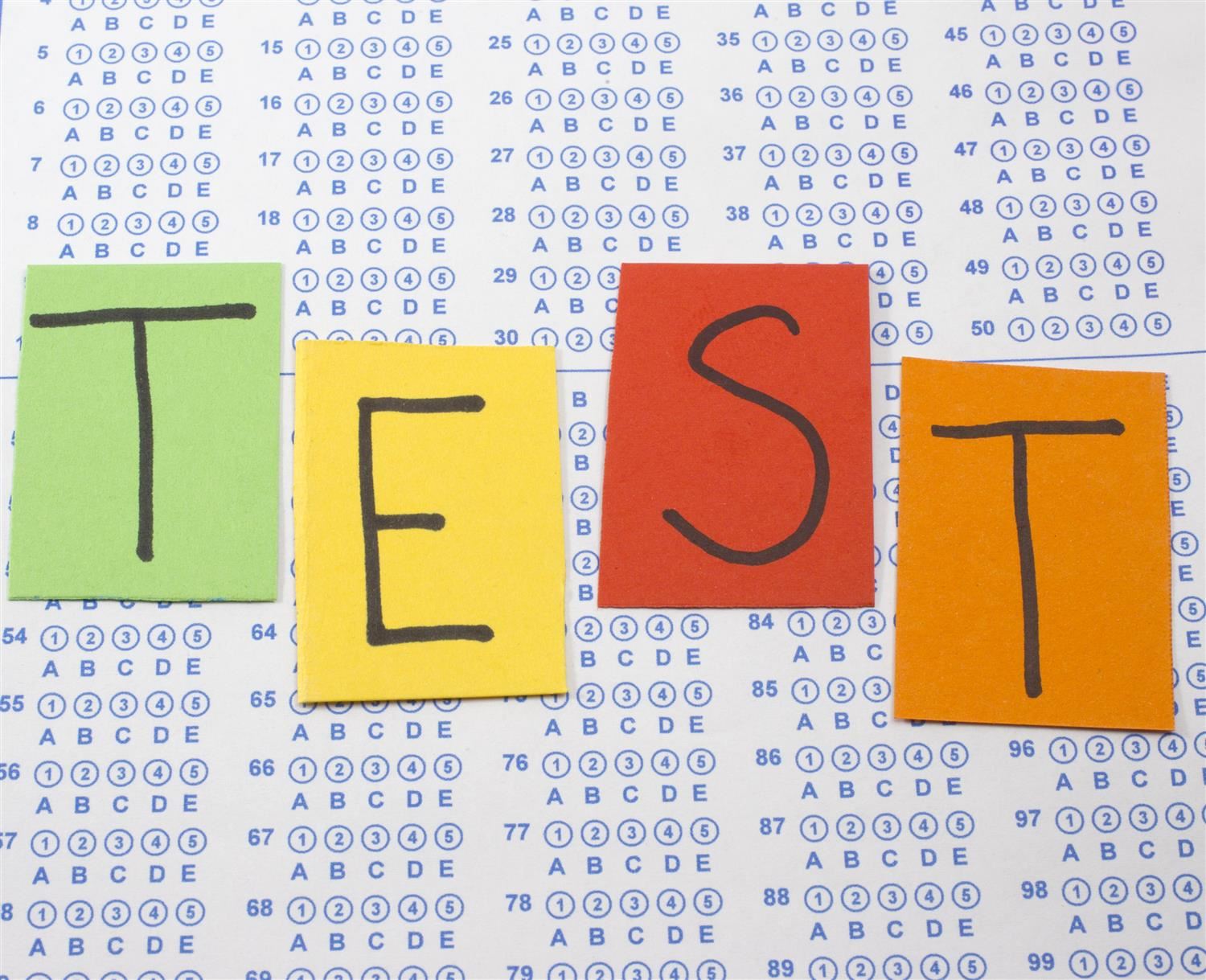 Scantron bubble answer sheet with the word TEST written on colored papers 